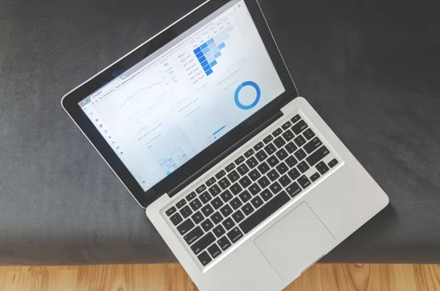 Overhead view of a laptop showing data visualizations and charts on its screen. Email marketing analytics tools: a practical evaluation and pilot guide