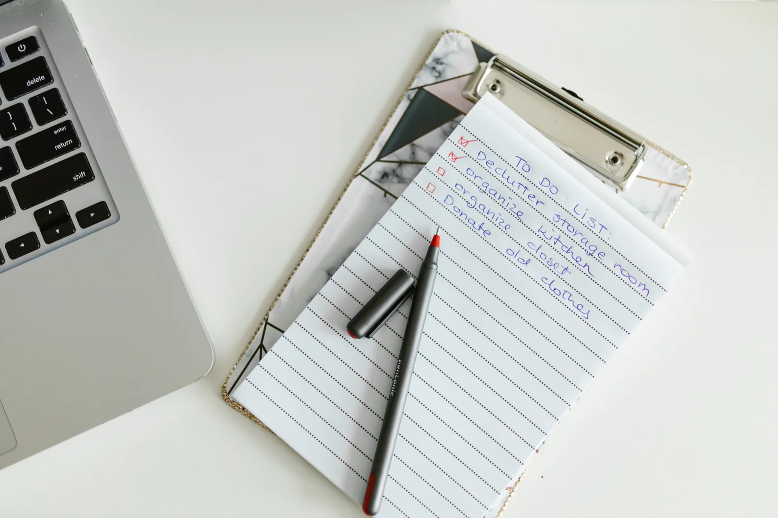A neatly organized to-do list on a clipboard next to a laptop and pen, conveying productivity. 8 checks that make an email segmentation checklist worth trusting