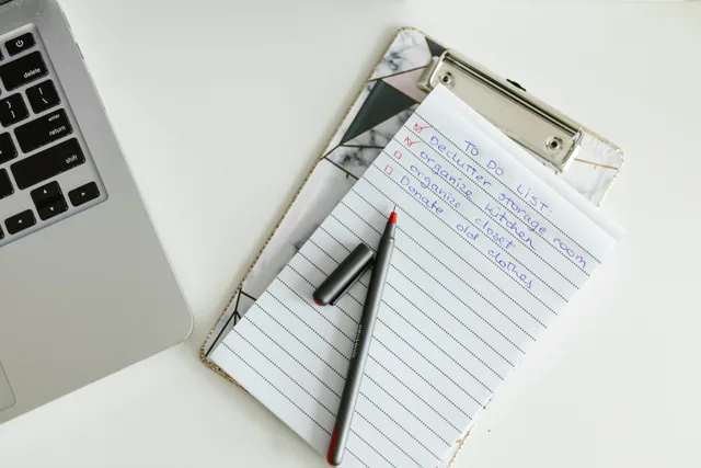 A neatly organized to-do list on a clipboard next to a laptop and pen, conveying productivity. 8 checks that make an email segmentation checklist worth trusting