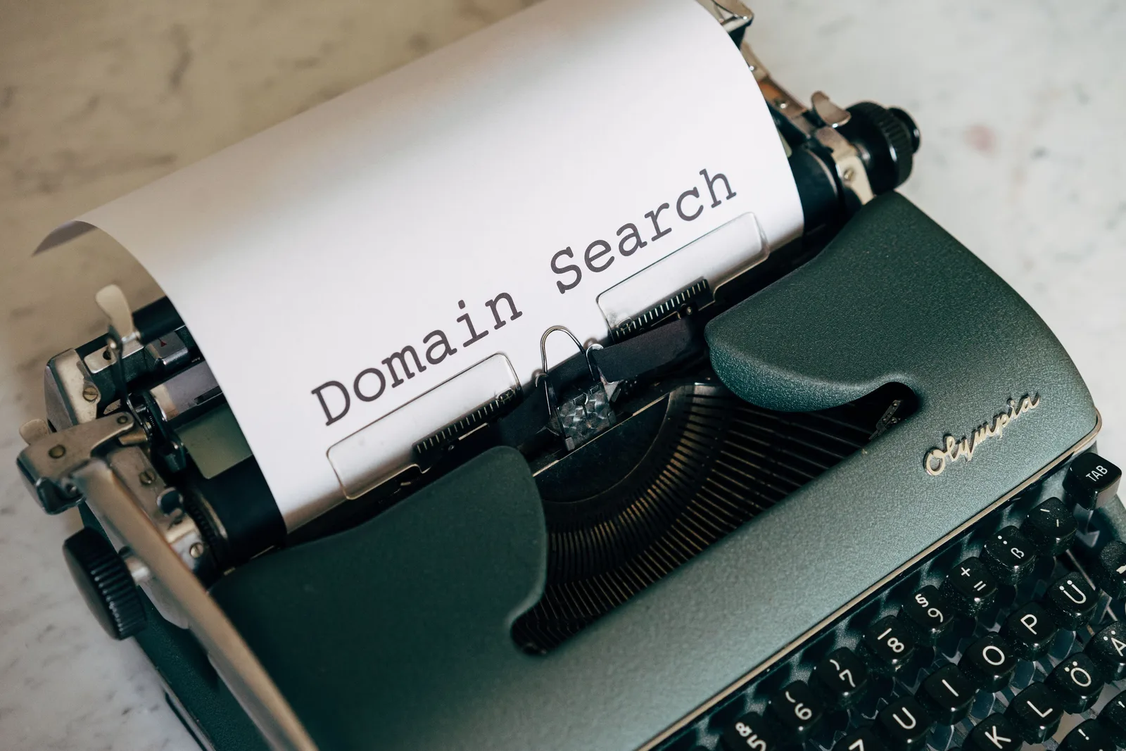 Close-up of a vintage typewriter with paper displaying 'Domain Search' text, ideal for retro themes. How to improve email deliverability without creative edits