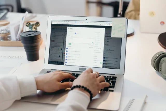 A person typing on a laptop in a bright, modern office setting, showing productivity and technology. How to improve email segmentation by rewriting vague labels